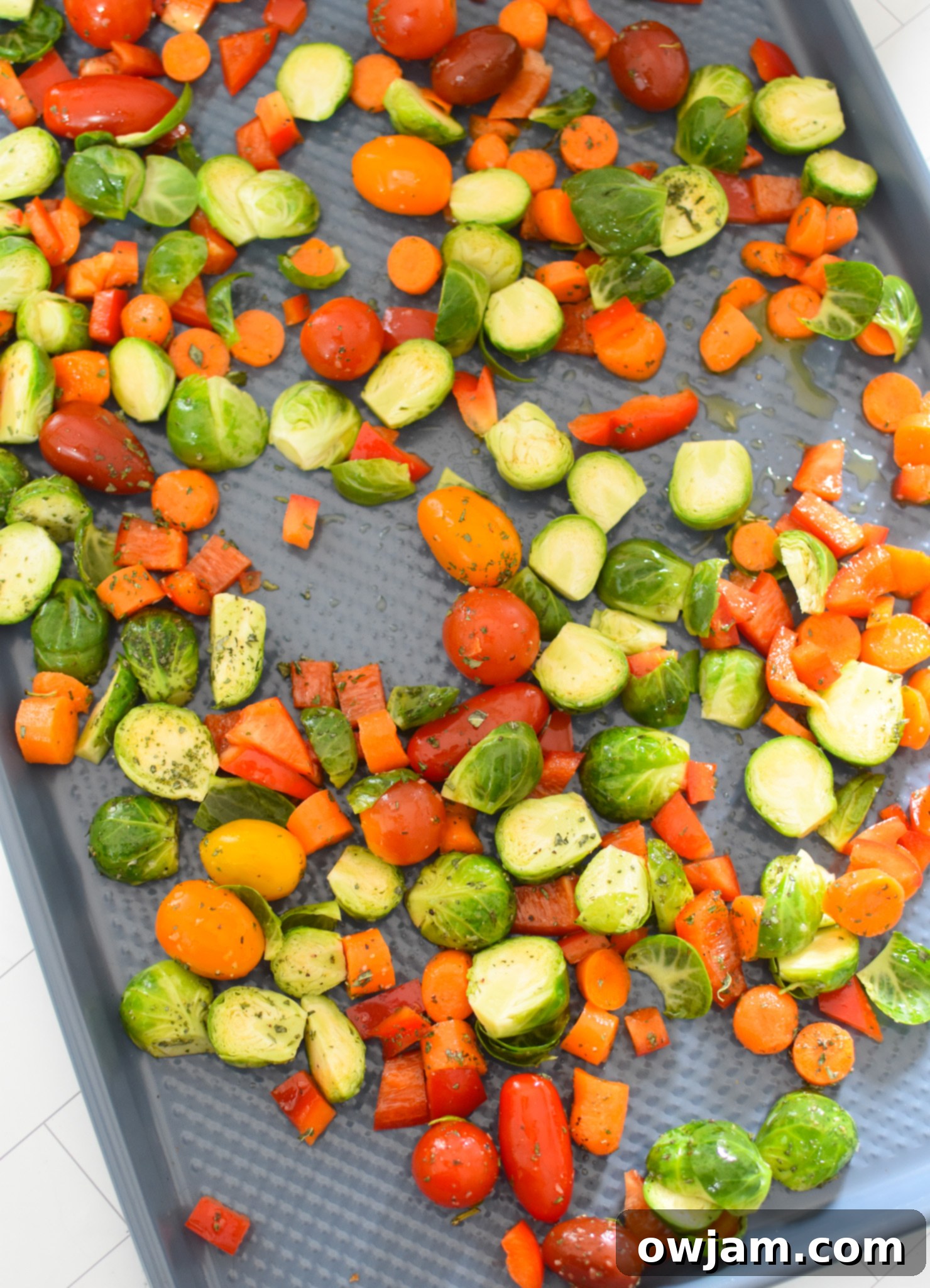 Roasted Vegetable Goat Cheese Flatbread Pizza Recipe vegetables spread on a baking sheet.