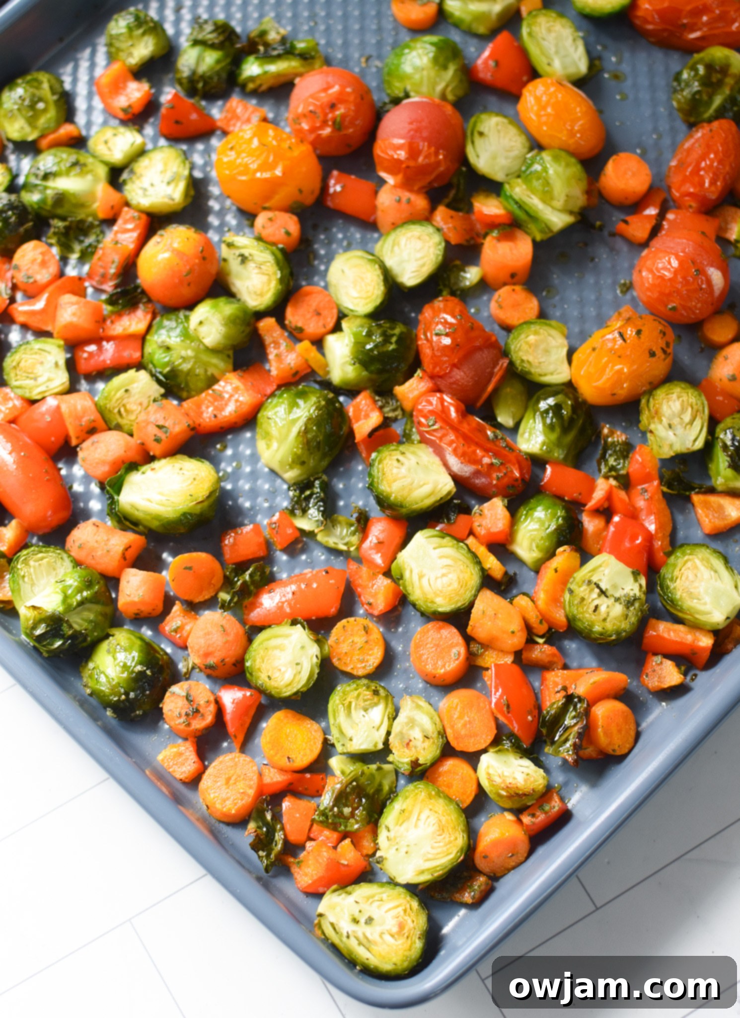 Roasted Vegetable Goat Cheese Flatbread Pizza Recipe vegetables roasting on a baking sheet.