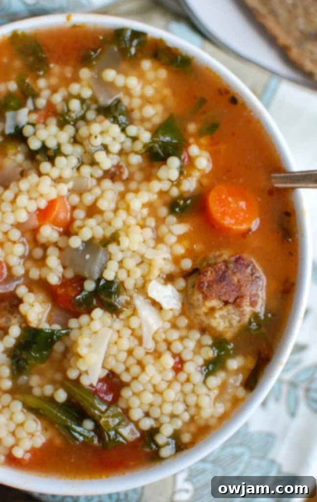 A bowl of delicious and healthy Italian Wedding Soup with turkey meatballs, greens, and pasta