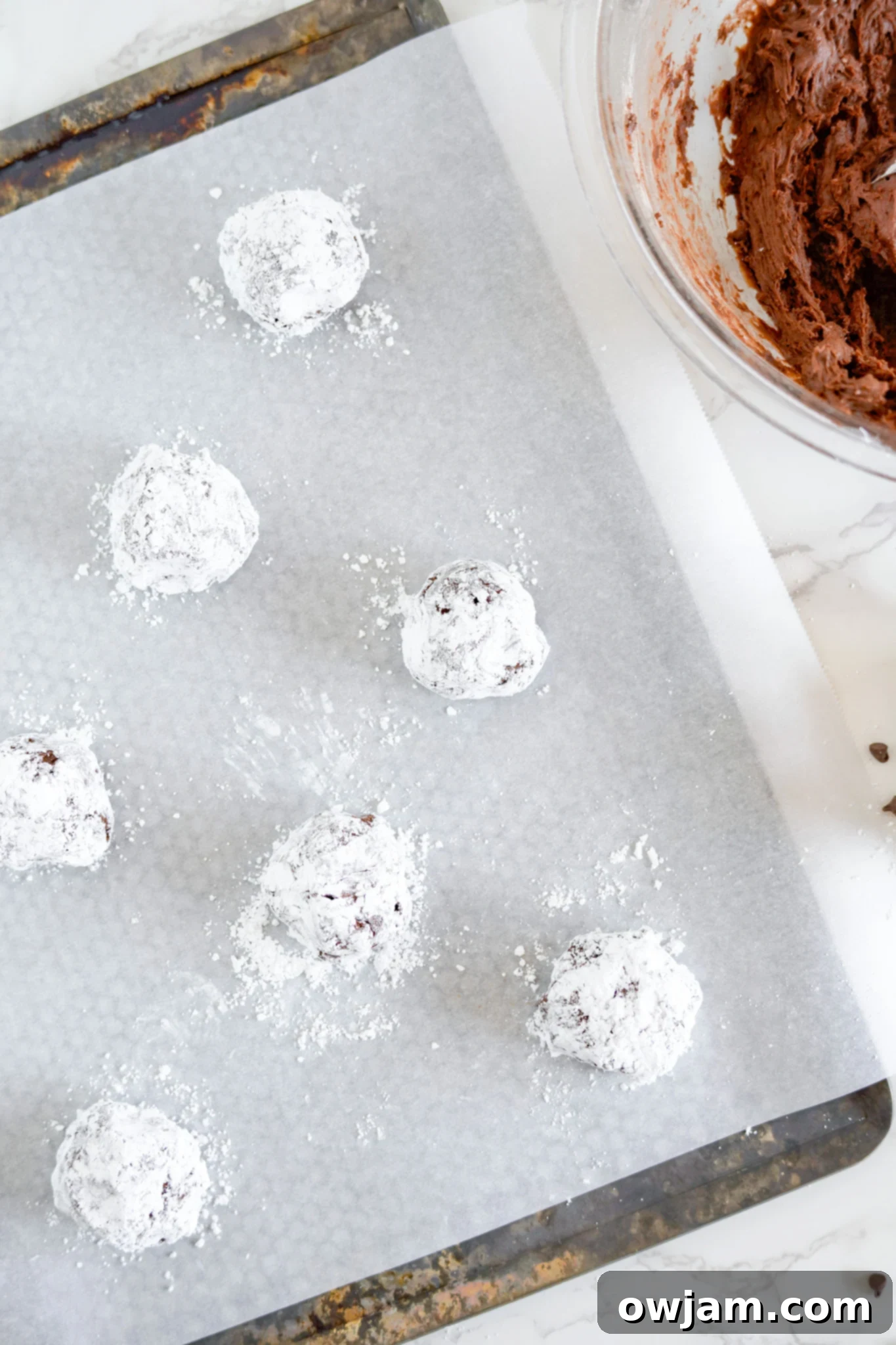 Decadent Chocolate Crinkle Cookies 11 Chocolate Crinkle Cookie Recipe on a baking sheet.