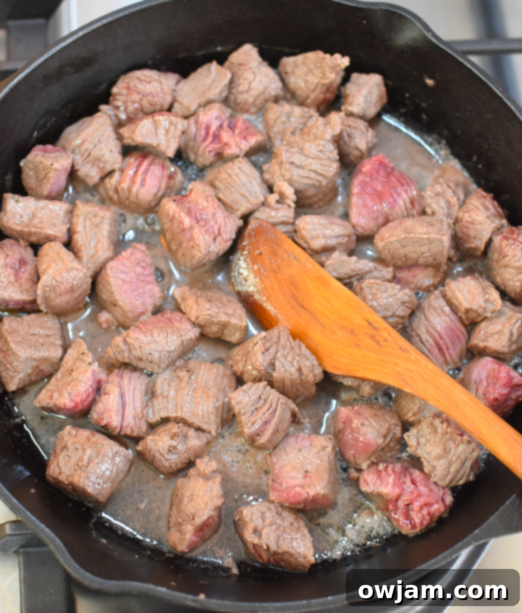 Hearty Slow Cooker Beef Barley Soup 6 Cubed beef browning in a skillet with olive oil, a crucial step for flavor.