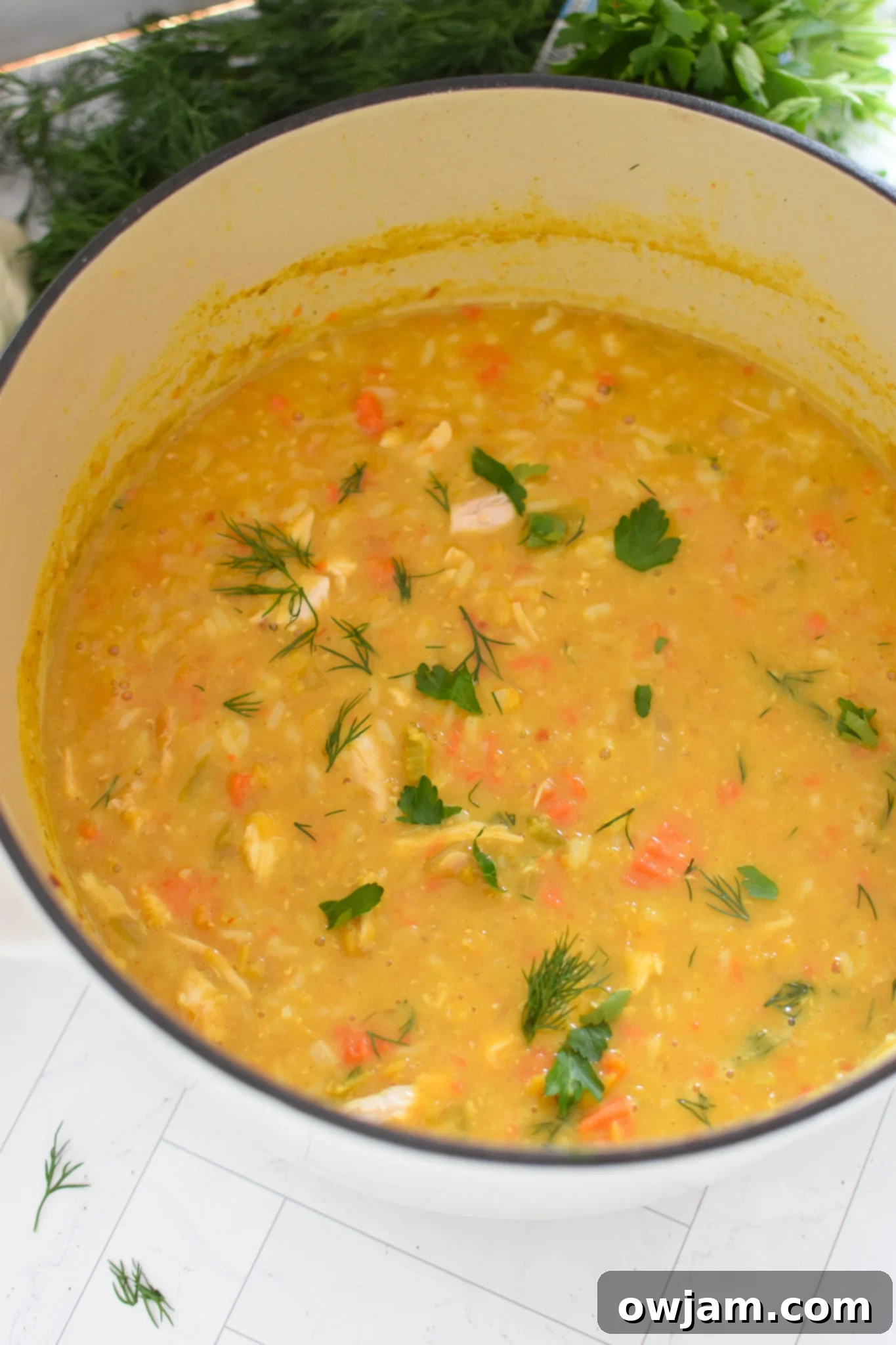 A large pot of Chicken Lentil Soup simmering on the stove, showing the cooking process.