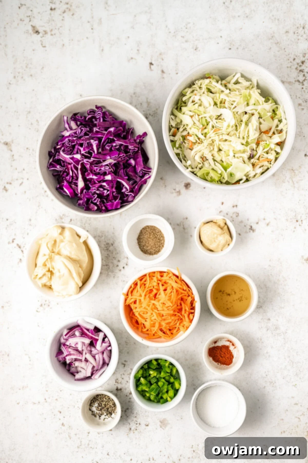 Spicy Jalapeno Coleslaw 4 A selection of fresh ingredients for Jalapeño Coleslaw, including cabbage, carrots, and jalapeños.