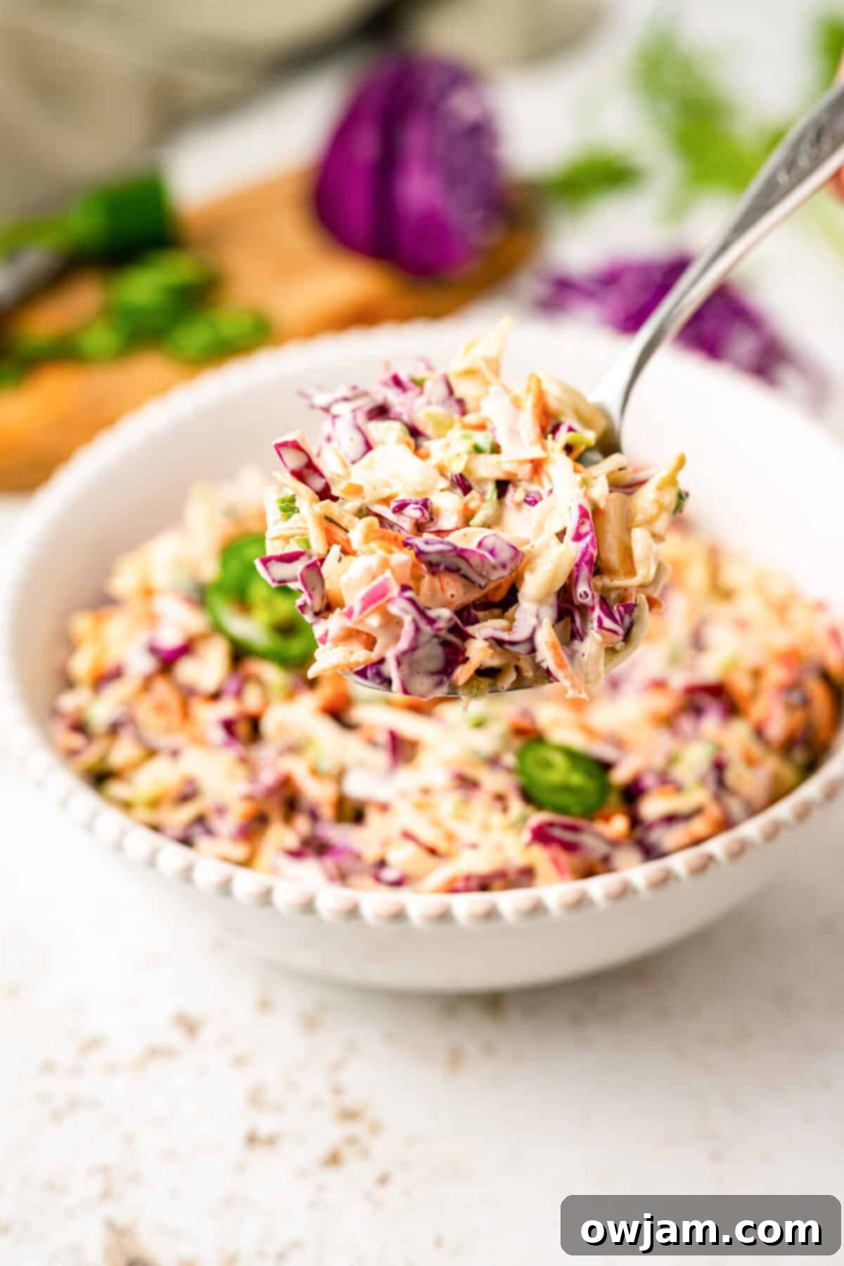 Spicy Jalapeno Coleslaw 5 Close-up of freshly mixed Jalapeño Coleslaw in a white bowl, ready to be served.