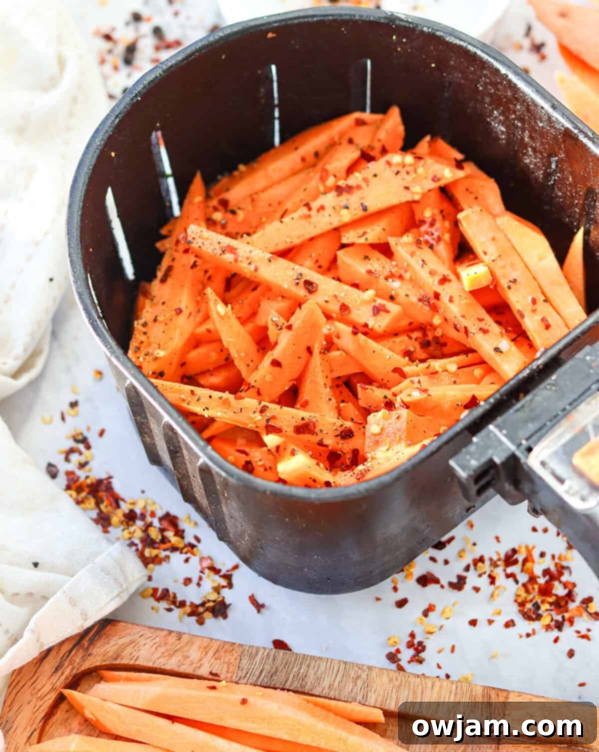 Air Fryer Sweet Potato Fries in an air fryer basket 