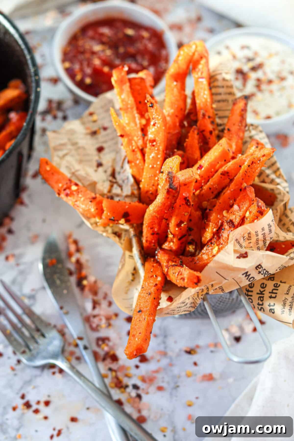 Air Fryer Sweet Potato Fries in a cup with parchment paper 