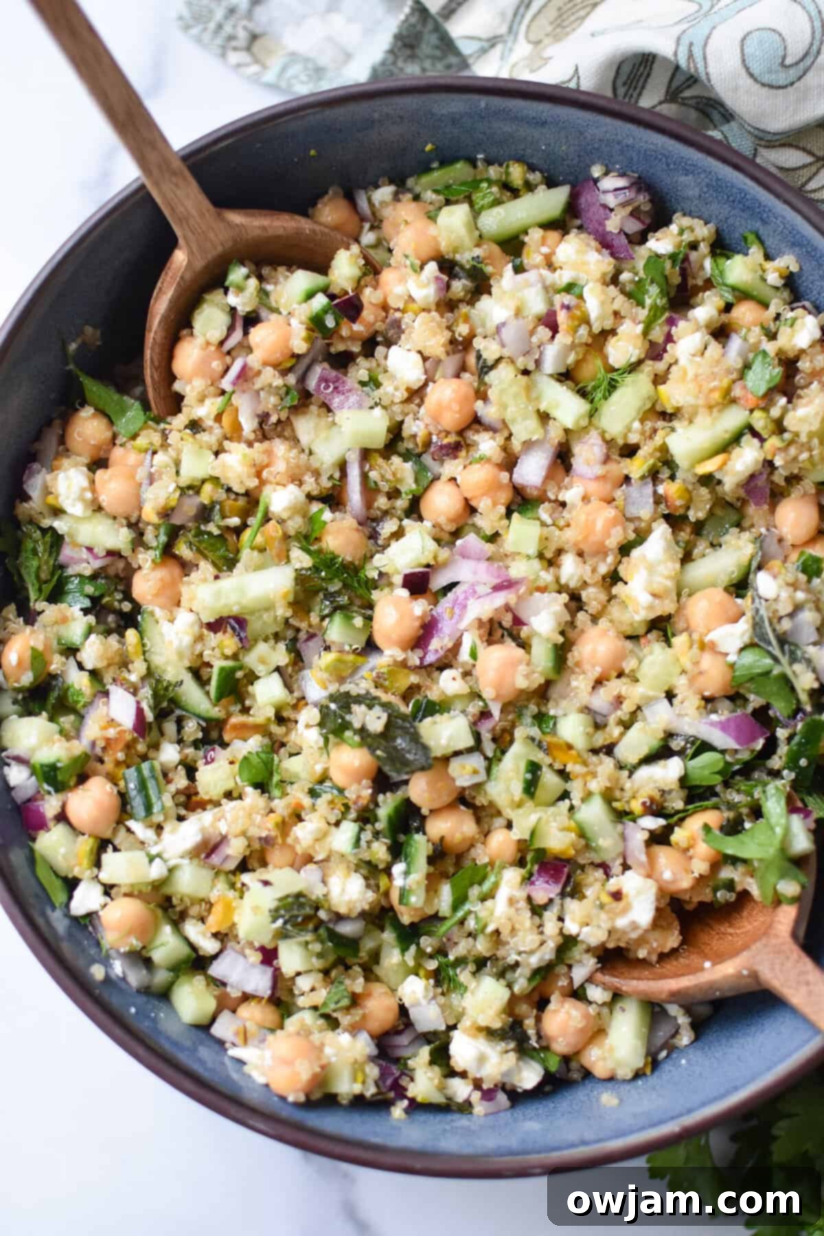 salad ingredients mixed in a blue bowl.