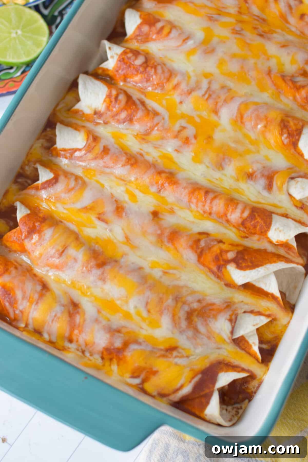 Simple Pork Enchiladas in Minutes 7 A freshly baked casserole dish of pork enchiladas, hot out of the oven, with perfectly melted and golden-brown cheese topping.