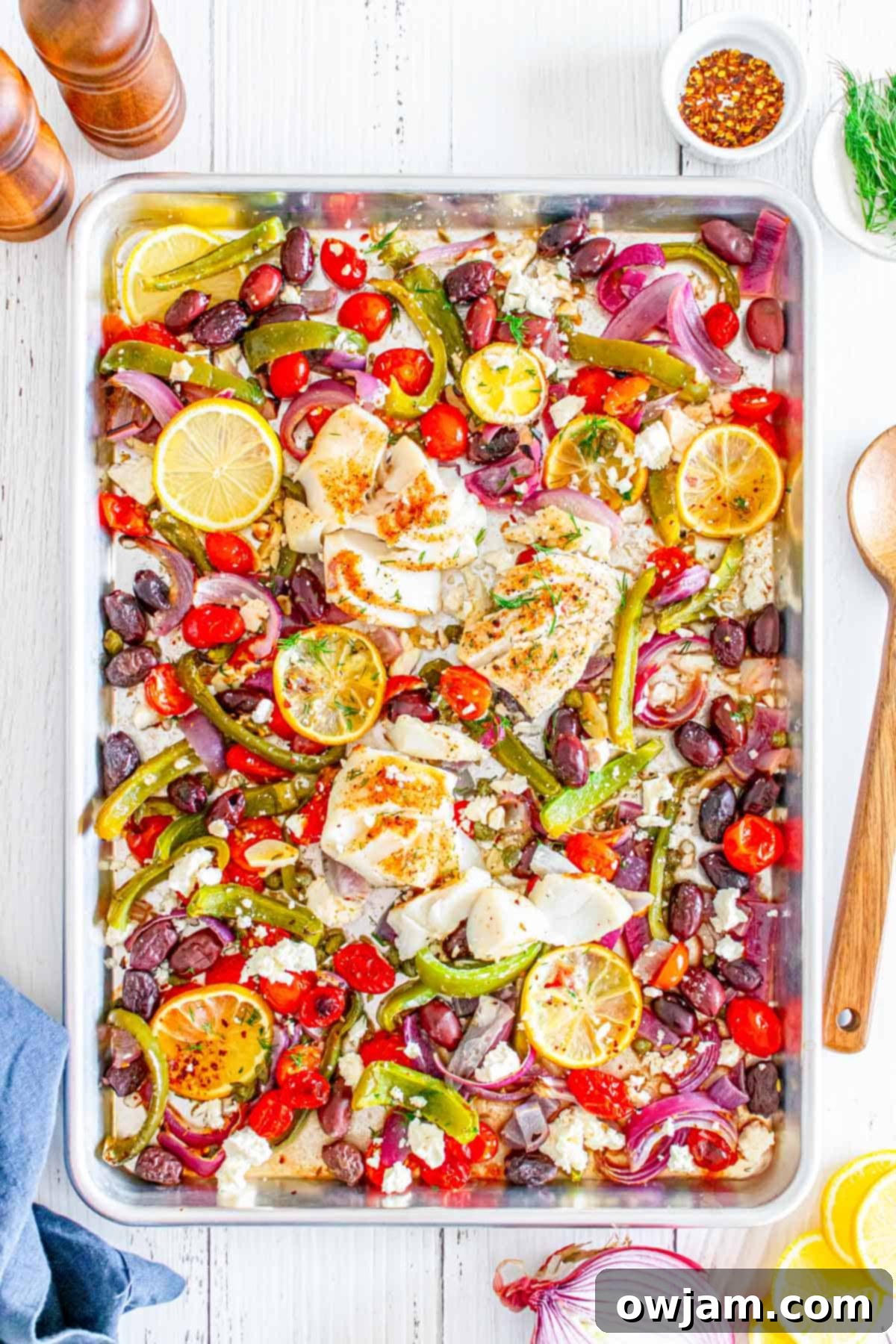 Sheet Pan Mediterranean Cod on sheet pan with spoon