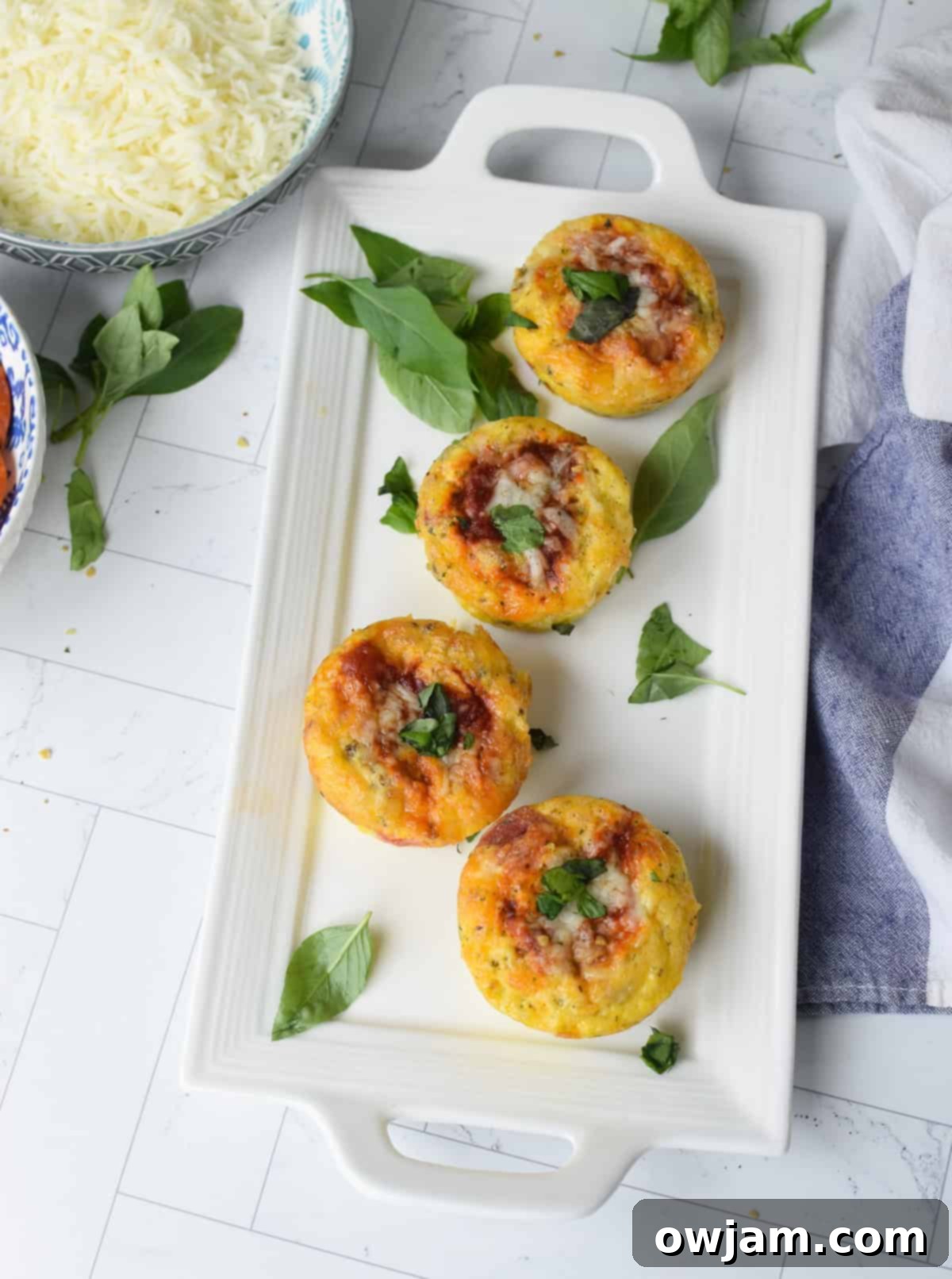 Cheesy Pizza Egg Bites 11 Two Pizza Egg Muffins on a clean white plate