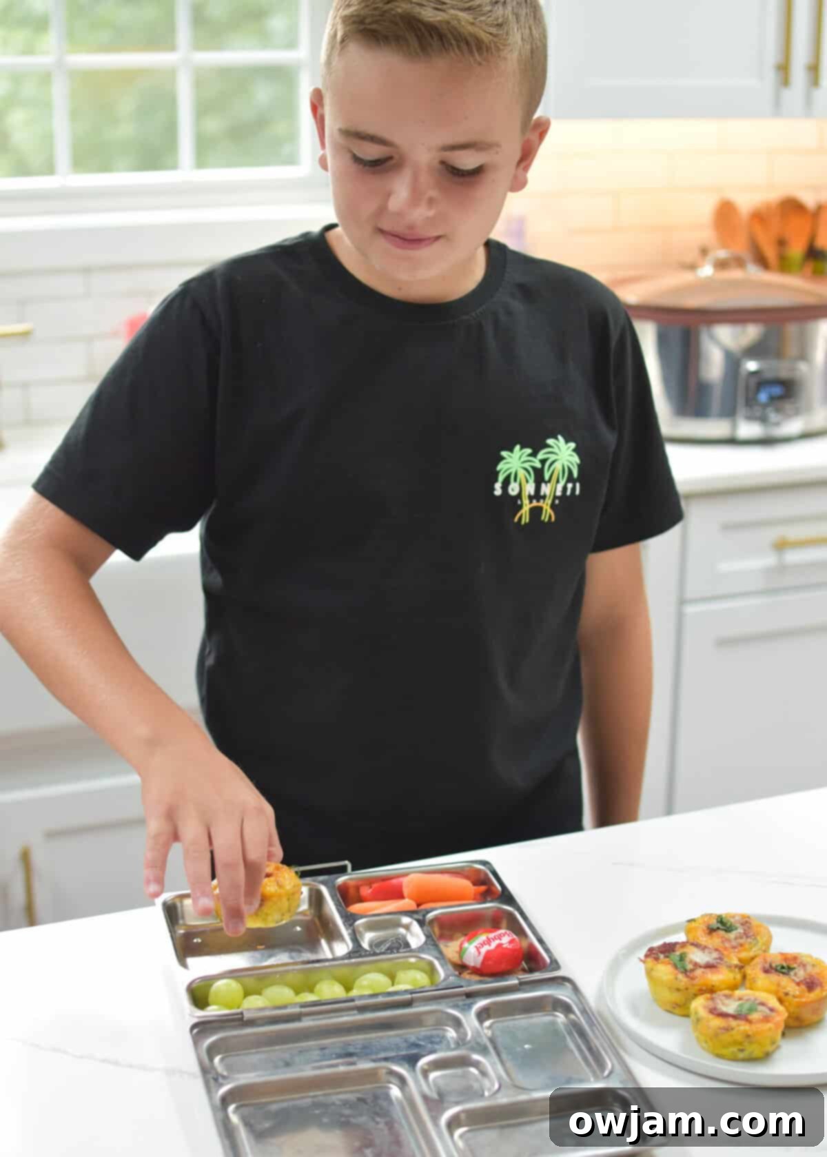 Cheesy Pizza Egg Bites 12 Hand packing a Pizza Egg Muffin into a lunchbox