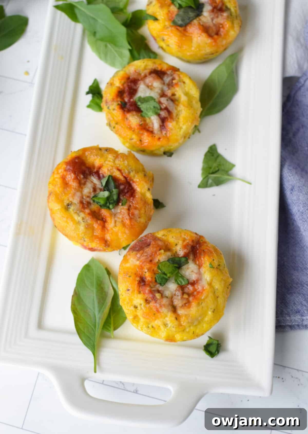Cheesy Pizza Egg Bites 3 Platter of freshly baked Pizza Egg Muffins, garnished and ready to serve