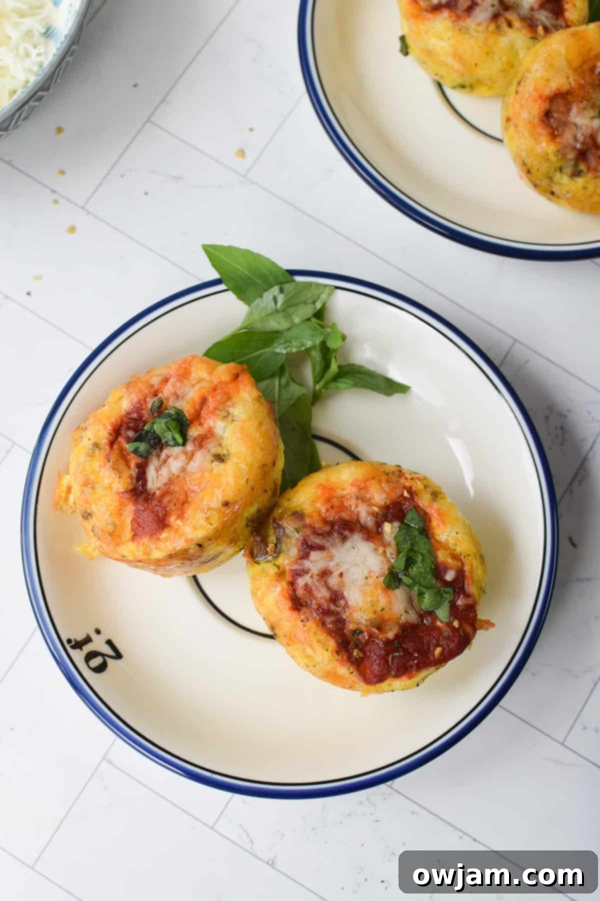Cheesy Pizza Egg Bites 5 Pizza Egg Muffins arranged on a rustic round plate