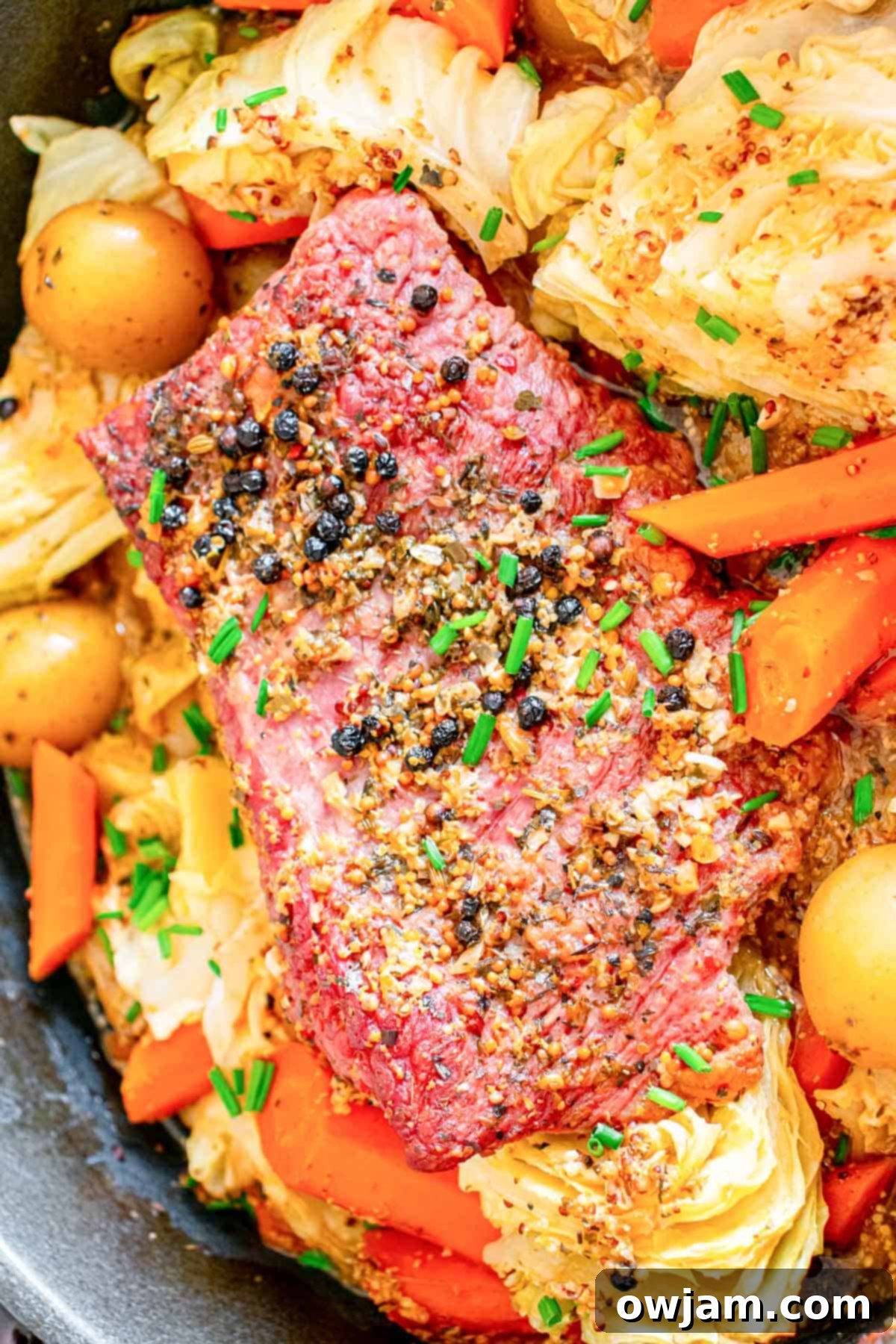 Homestyle Baked Corned Beef & Cabbage 3 Baked Corned Beef and Cabbage cooking in a Dutch oven with rich broth