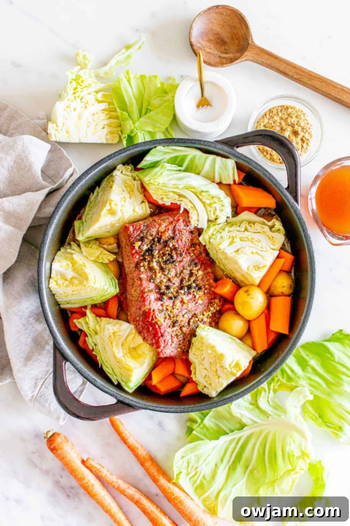 Homestyle Baked Corned Beef & Cabbage 9 Baked Corned Beef and Cabbage with vegetables in a pot, ready to be served