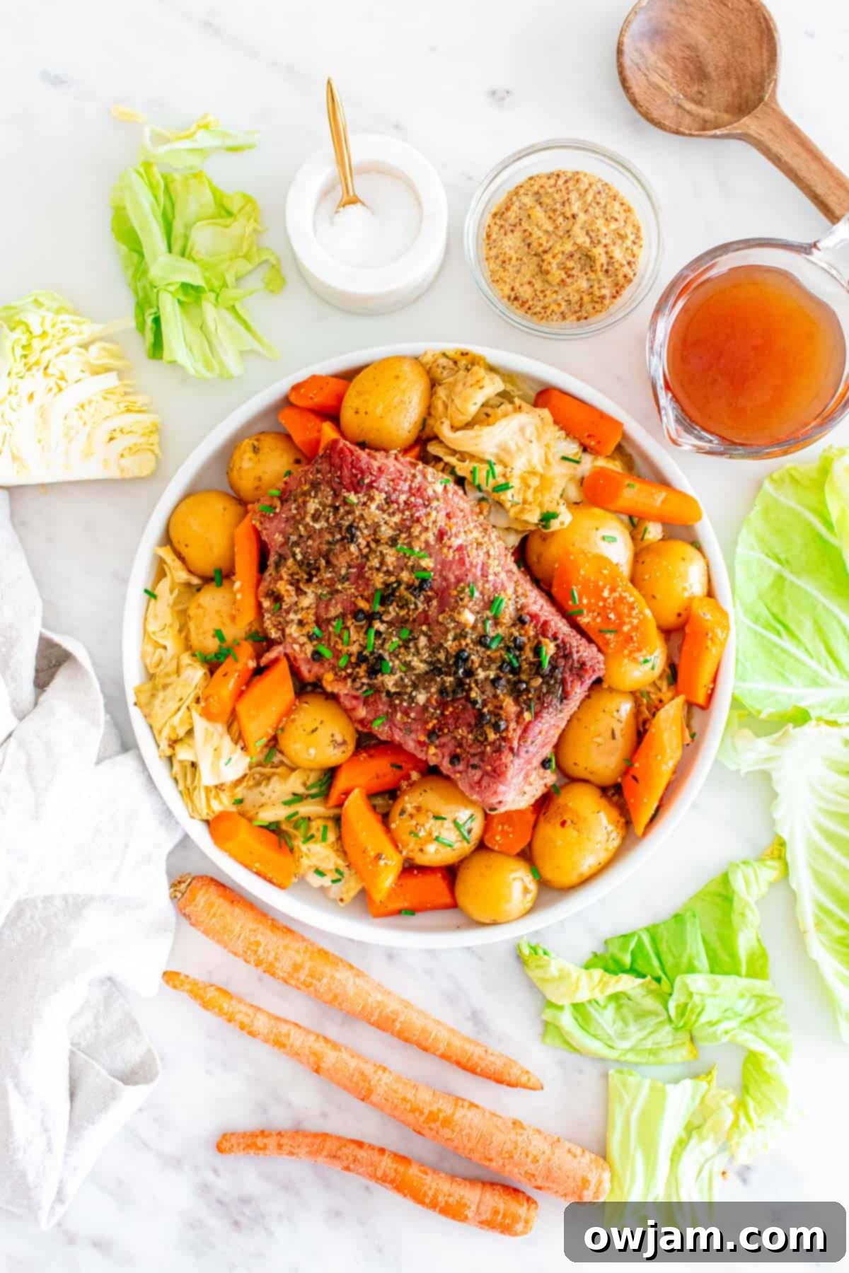 Homestyle Baked Corned Beef & Cabbage 10 A serving of Baked Corned Beef and Cabbage with sauce on a rustic plate