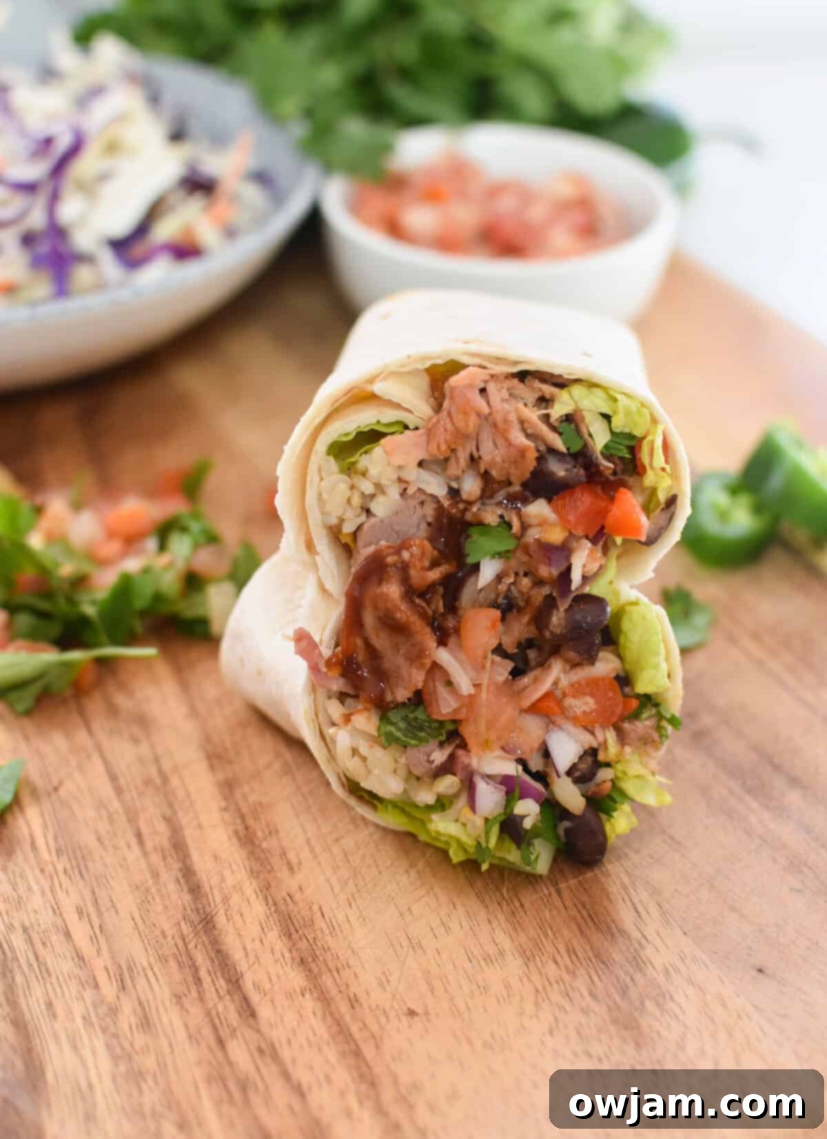 Ultimate Pulled Pork Burritos 3 Pulled Pork Burritos on a cutting board