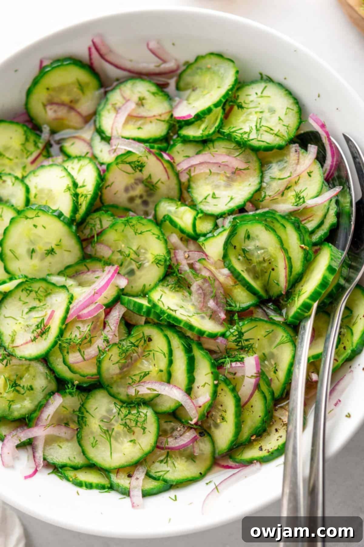 Close-up of Cucumber Onion Salad in a bowl, ready to be served, showing its fresh, vibrant appearance