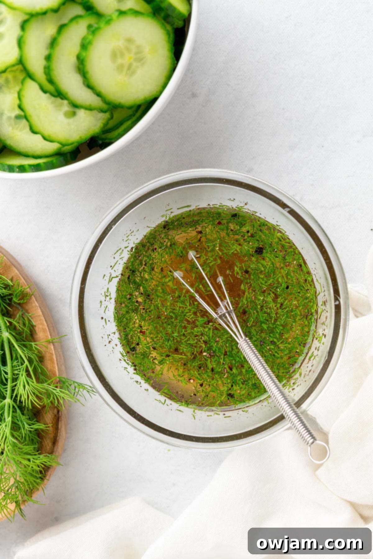 Close-up of the tangy dill vinaigrette dressing in a small bowl, ready for the salad