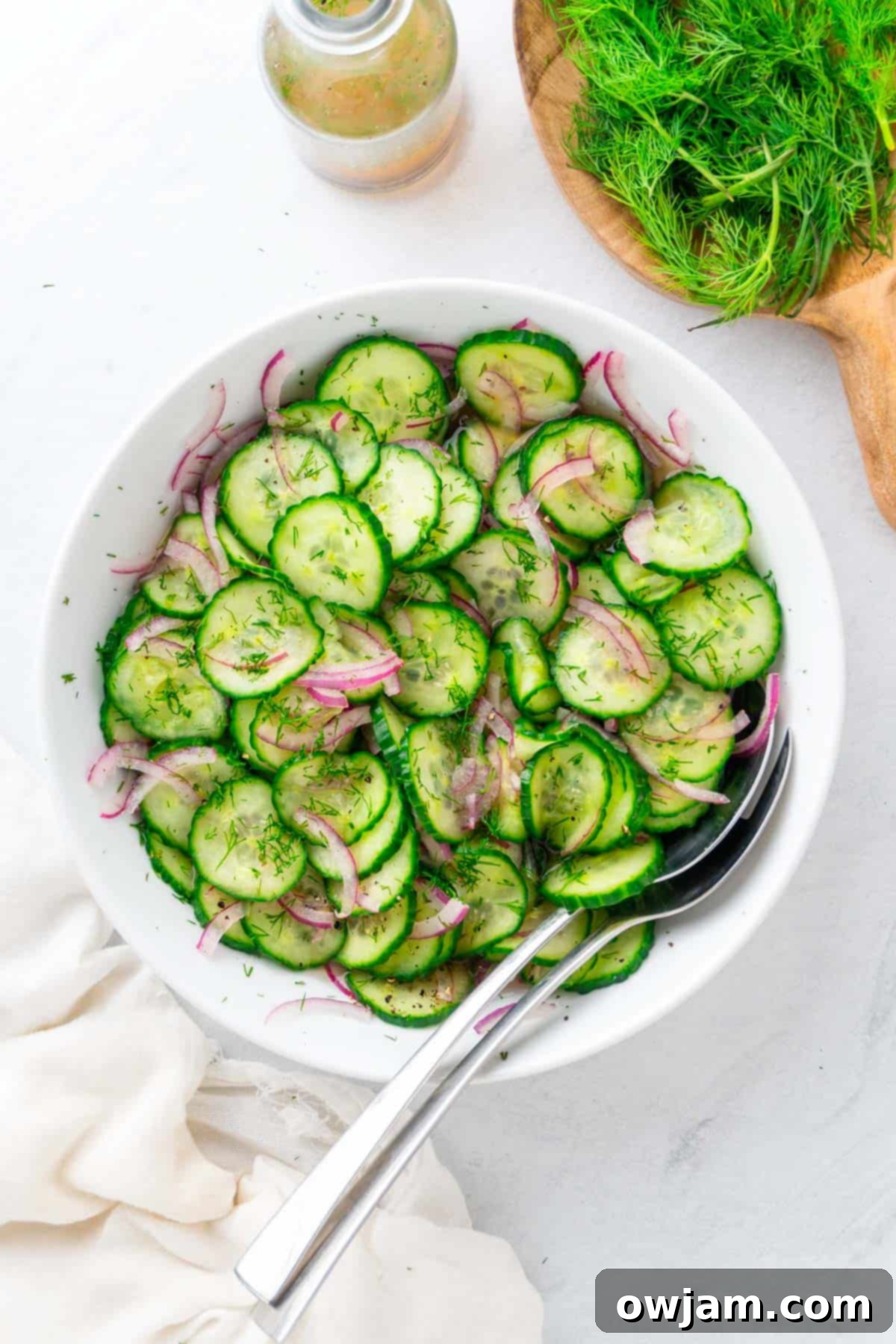 Vibrant Cucumber Onion Salad with serving spoons, ready to be enjoyed