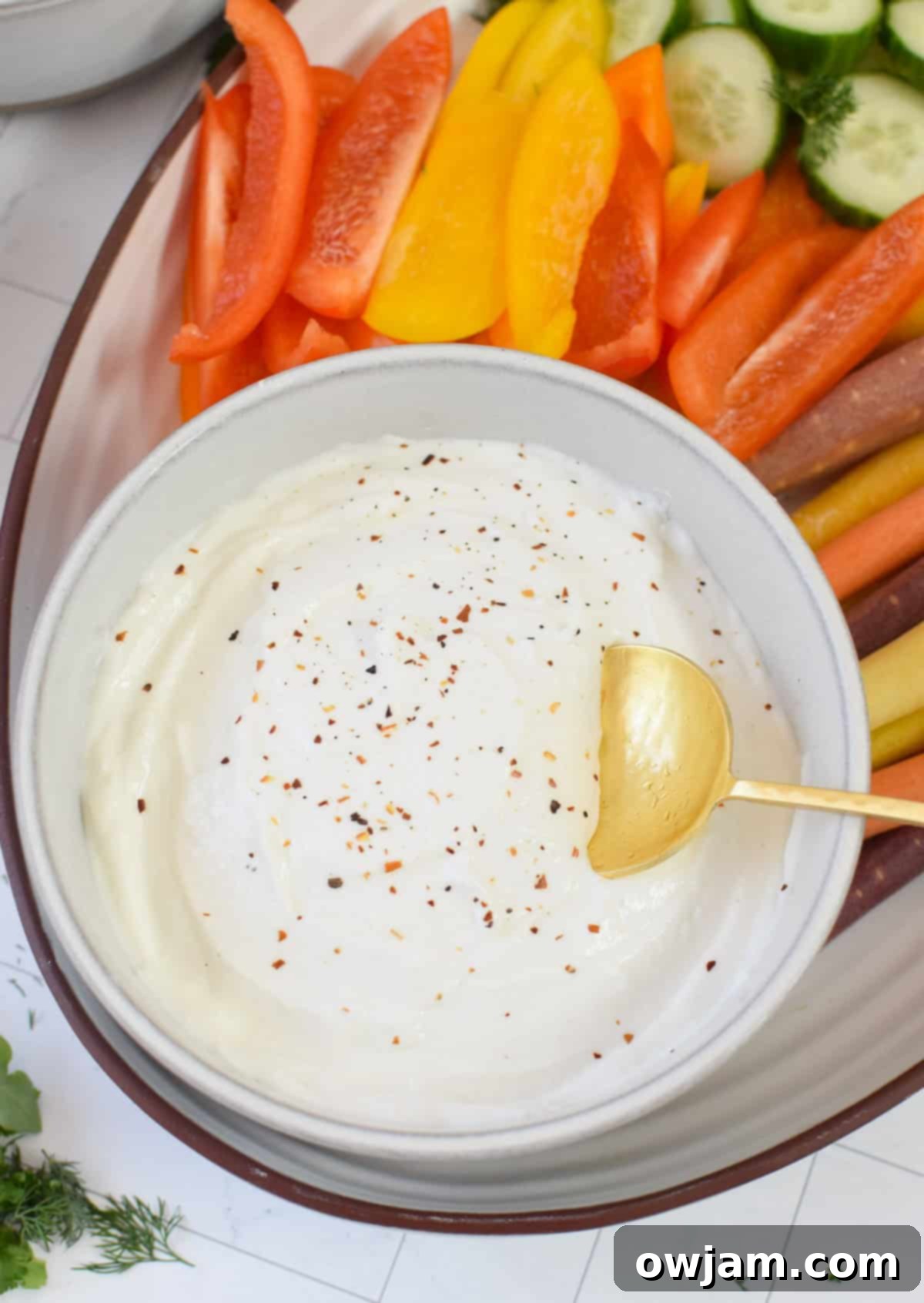 Velvety Cottage Cheese 2 Whipped Cottage Cheese with gold spoon, garnished with fresh herbs