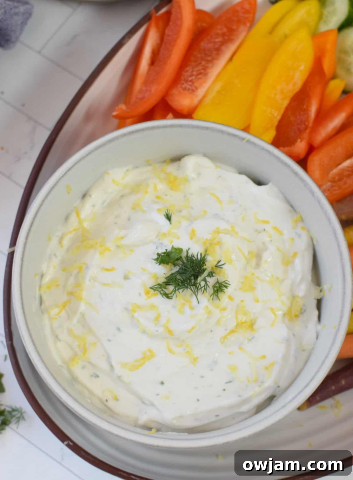 Velvety Cottage Cheese 5 Whipped Lemon Herb Cottage Cheese garnished with herbs and a lemon wedge