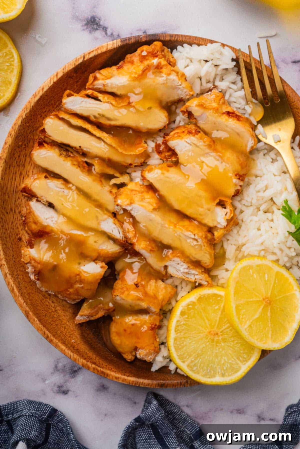Air Fryer Chicken Breast slices in a bowl with lemon sauce