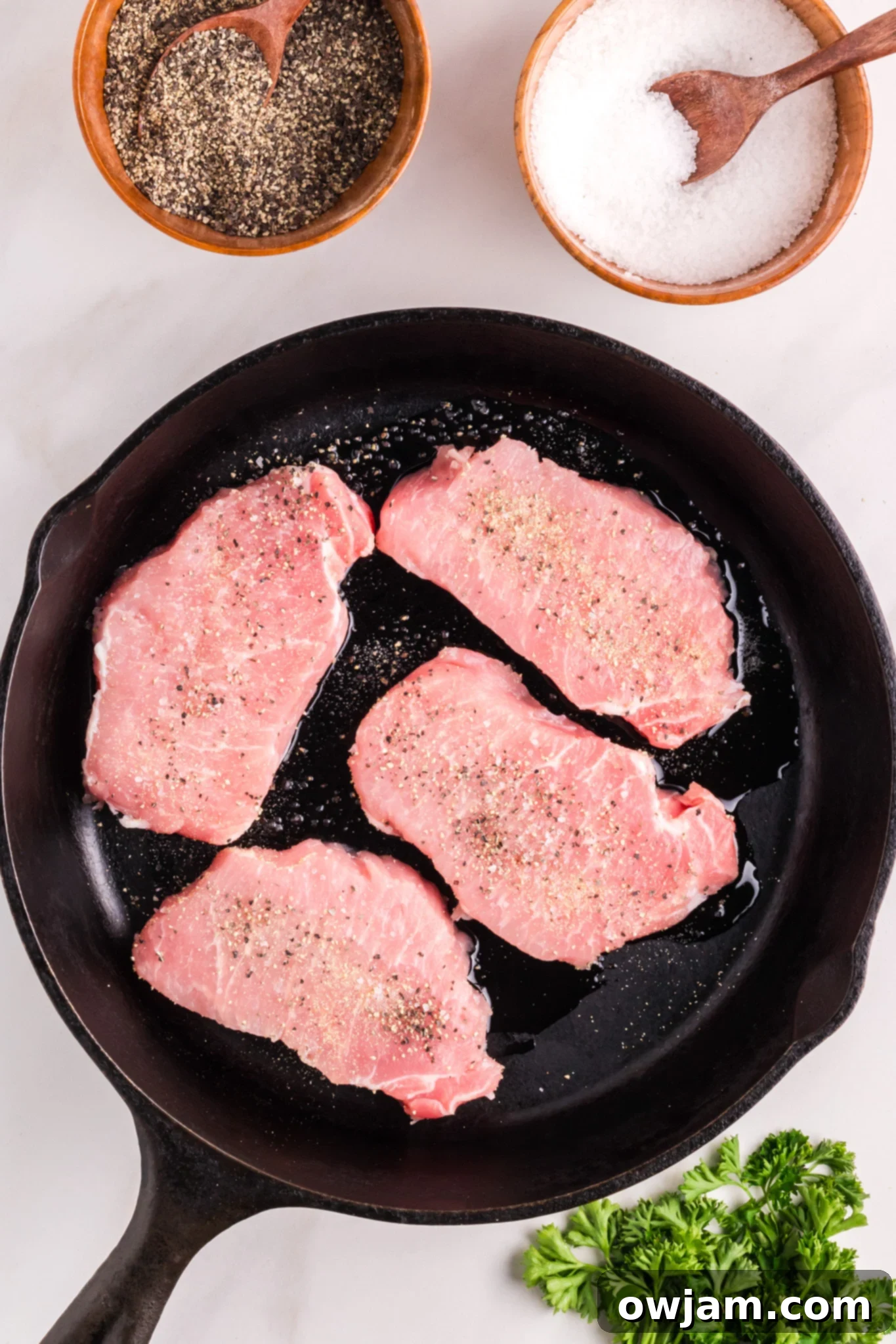 Pan Seared Pork Chops pork chops in a black skillet