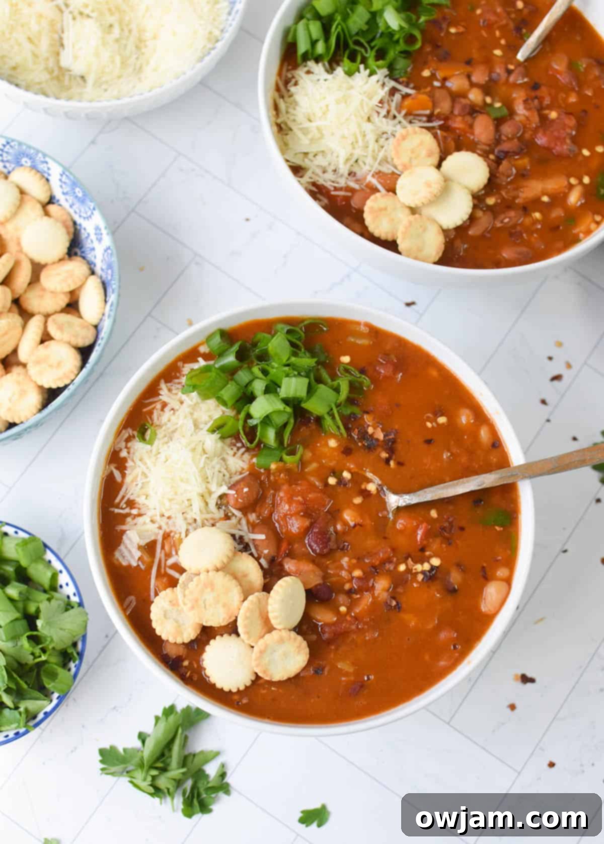 A steaming bowl of Instant Pot 15 Bean Soup, garnished and ready to serve.