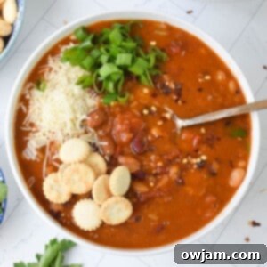 A top-down shot of a bowl of Instant Pot 15 Bean Soup, garnished and ready.