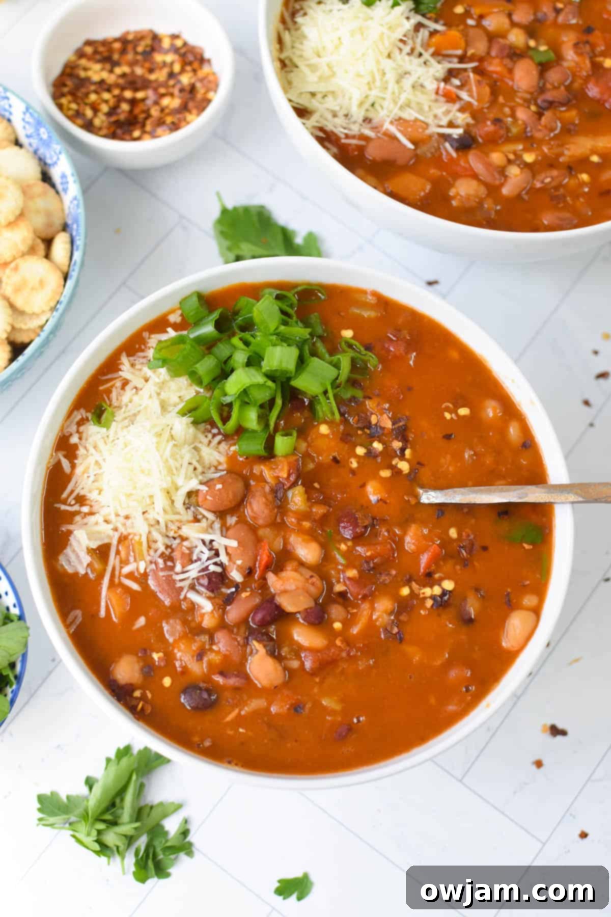 A close-up of a bowl of Instant Pot 15 Bean Soup with a spoon, highlighting its rich texture and ingredients.