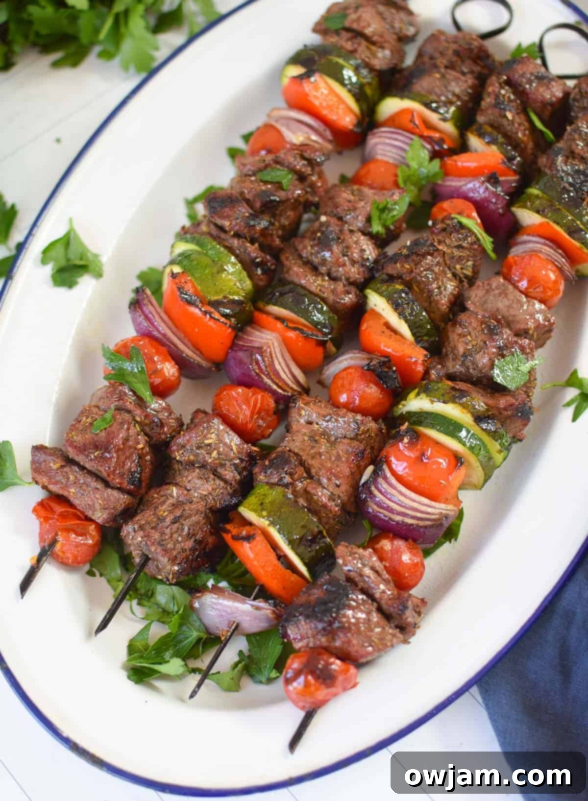 Authentic Greek Beef Souvlaki 6 Grilled Beef Souvlaki skewers on a white platter