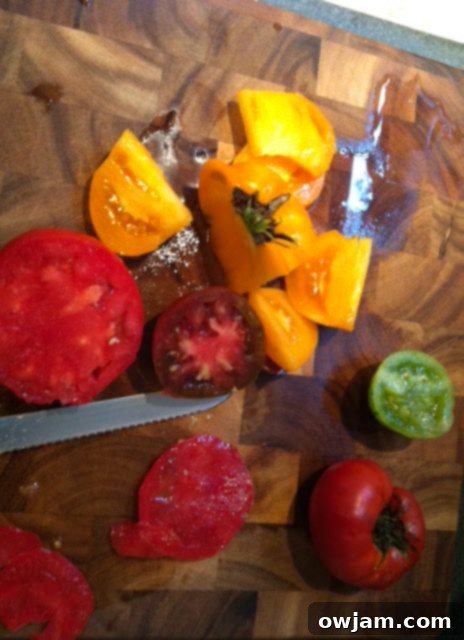 Perfectly sliced heirloom tomatoes, forming the base of the Heirloom Caprese Salad