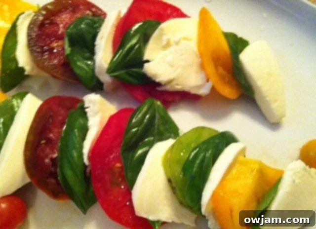 Heirloom Caprese Salad recipe beautifully displayed, courtesy of A Cedar Spoon blog