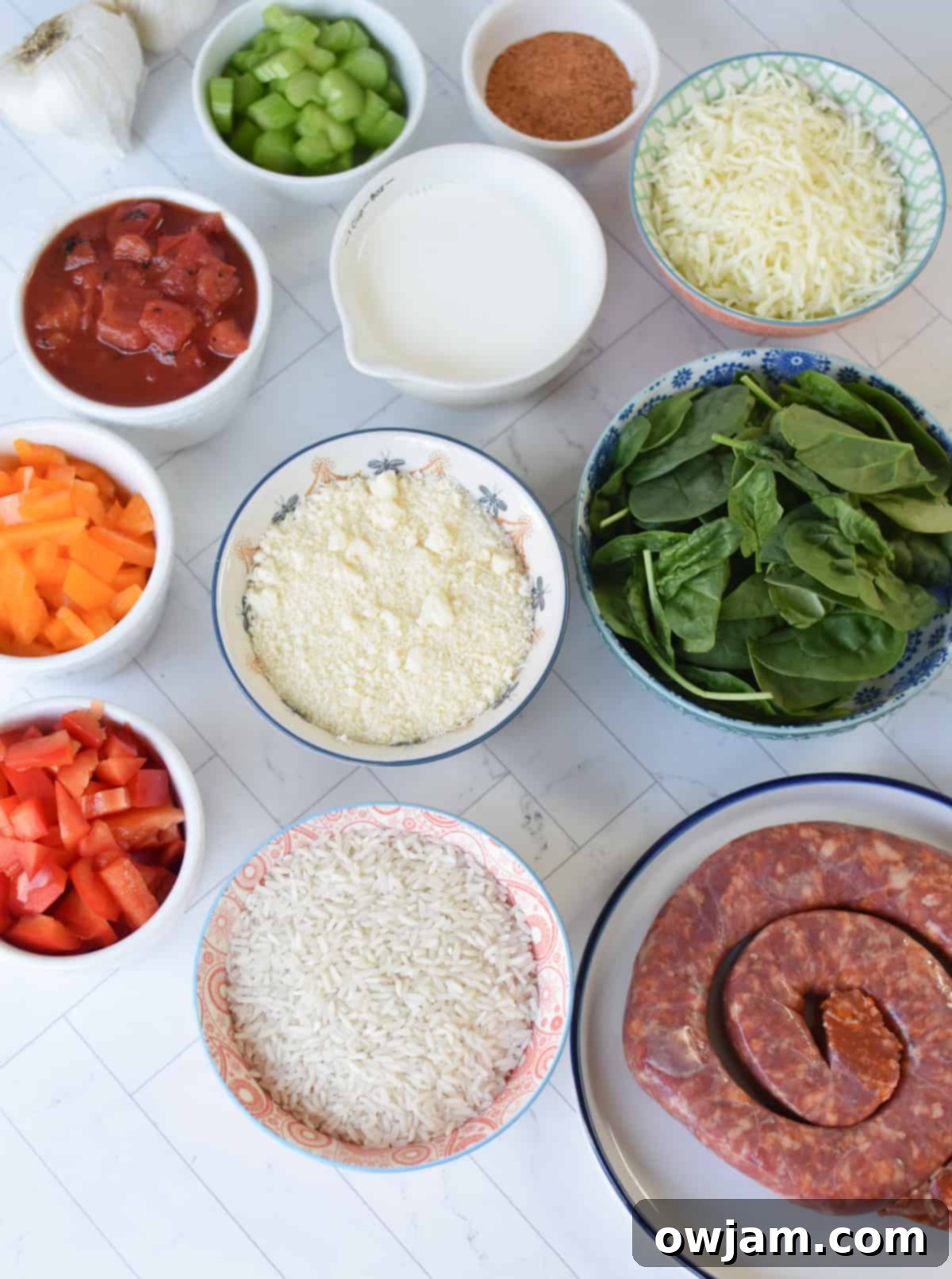 Creamy Cajun Sausage and Rice Skillet 4 Individual ingredients laid out for Creamy Cajun Sausage Rice Skillet