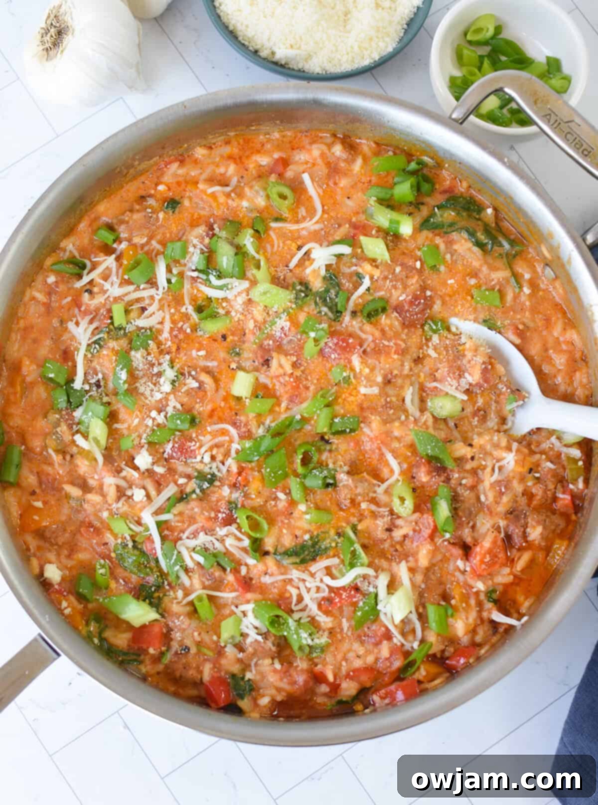 Creamy Cajun Sausage and Rice Skillet 9 Cream and cheese being added to Creamy Cajun Sausage Rice Skillet