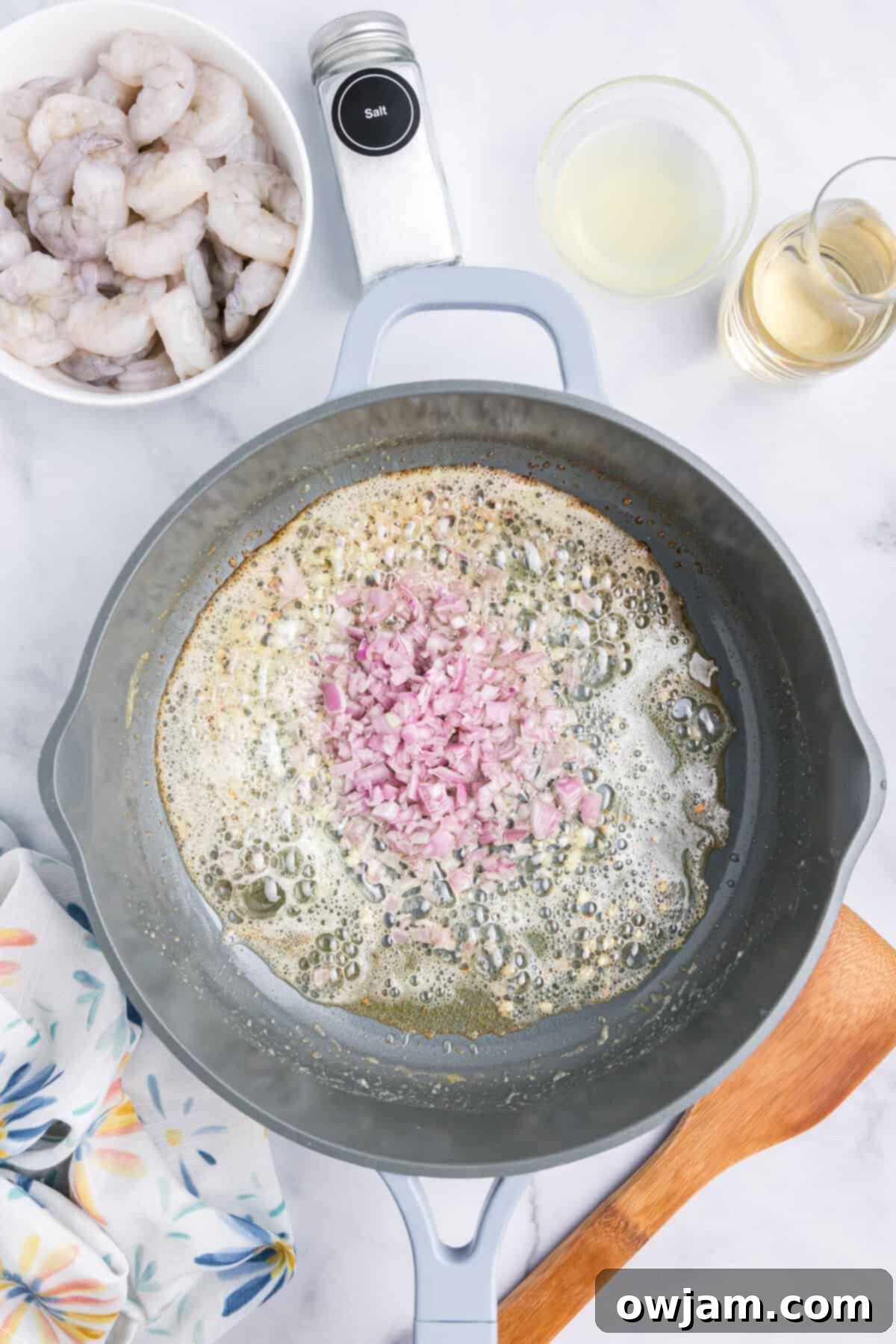 Zesty Lemon Shrimp with Orzo 6 Minced shallots and garlic sautéing in butter in a large skillet, forming the aromatic base for Lemon Shrimp and Orzo