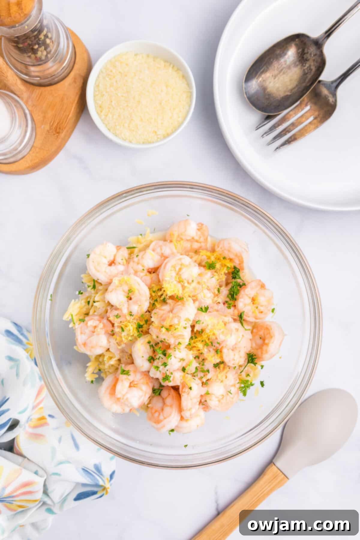 Zesty Lemon Shrimp with Orzo 8 Cooked Lemon Shrimp and Orzo pasta being gently mixed in a large bowl, ready for serving