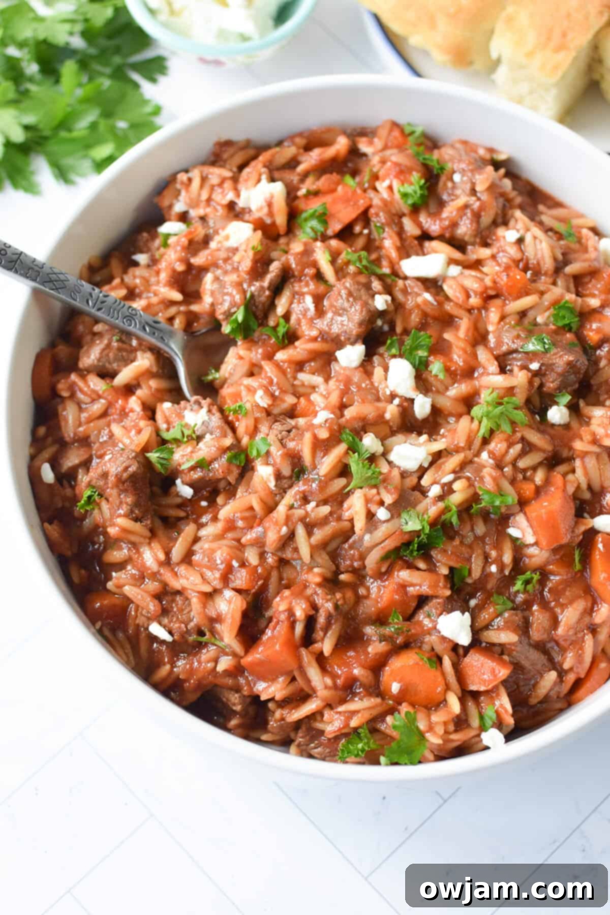 Greek Beef Stew with Orzo in a white bowl