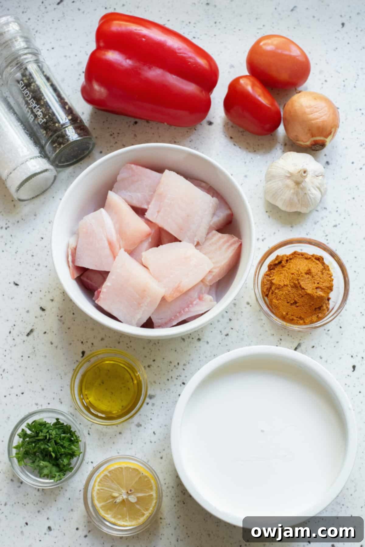 Luscious Coconut Fish Curry 4 A vibrant selection of ingredients laid out for Coconut Fish Curry, including fresh fish, vegetables, spices, and coconut milk.