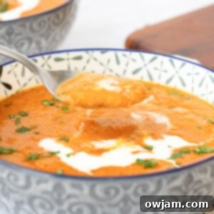 Spiced Tomato & Lentil Delight 10 Lentil Tomato Soup with spoon in a bowl
