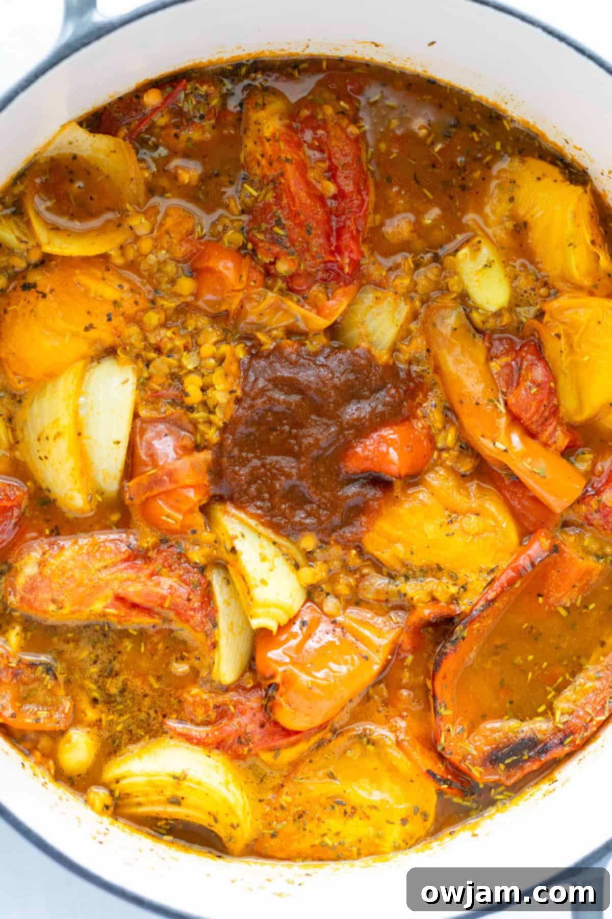 Spiced Tomato & Lentil Delight 7 Lentil Tomato Soup ingredients simmering in a Dutch oven, showing the rich color and creamy texture forming.