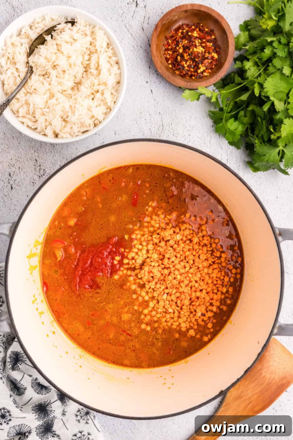 Simple Satisfying Red Lentil Dahl 8 Red lentils and crushed tomatoes simmering in vegetable broth with spices and vegetables in a Dutch oven