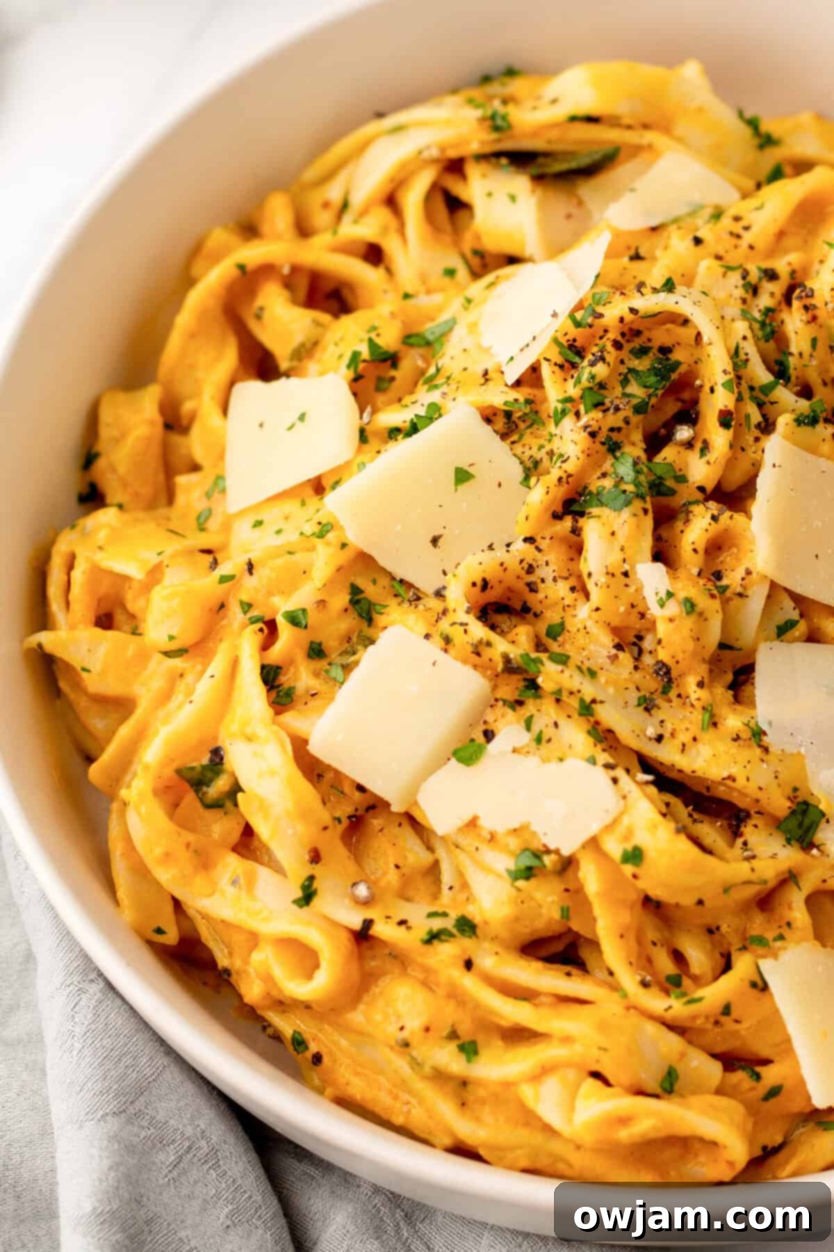 Velvety Pumpkin Pasta Sauce 10 Pumpkin Pasta Sauce in a bowl with cheese