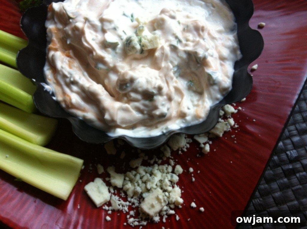 Close-up of the healthy Greek yogurt buffalo dip, showcasing its creamy texture and bits of blue cheese.