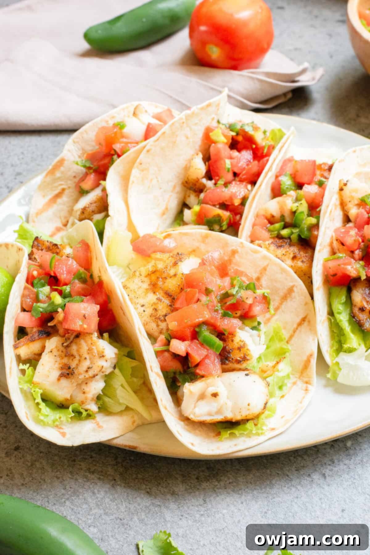 Flame-Kissed Fish Tacos 2 Blackened Fish Tacos on a plate with salsa