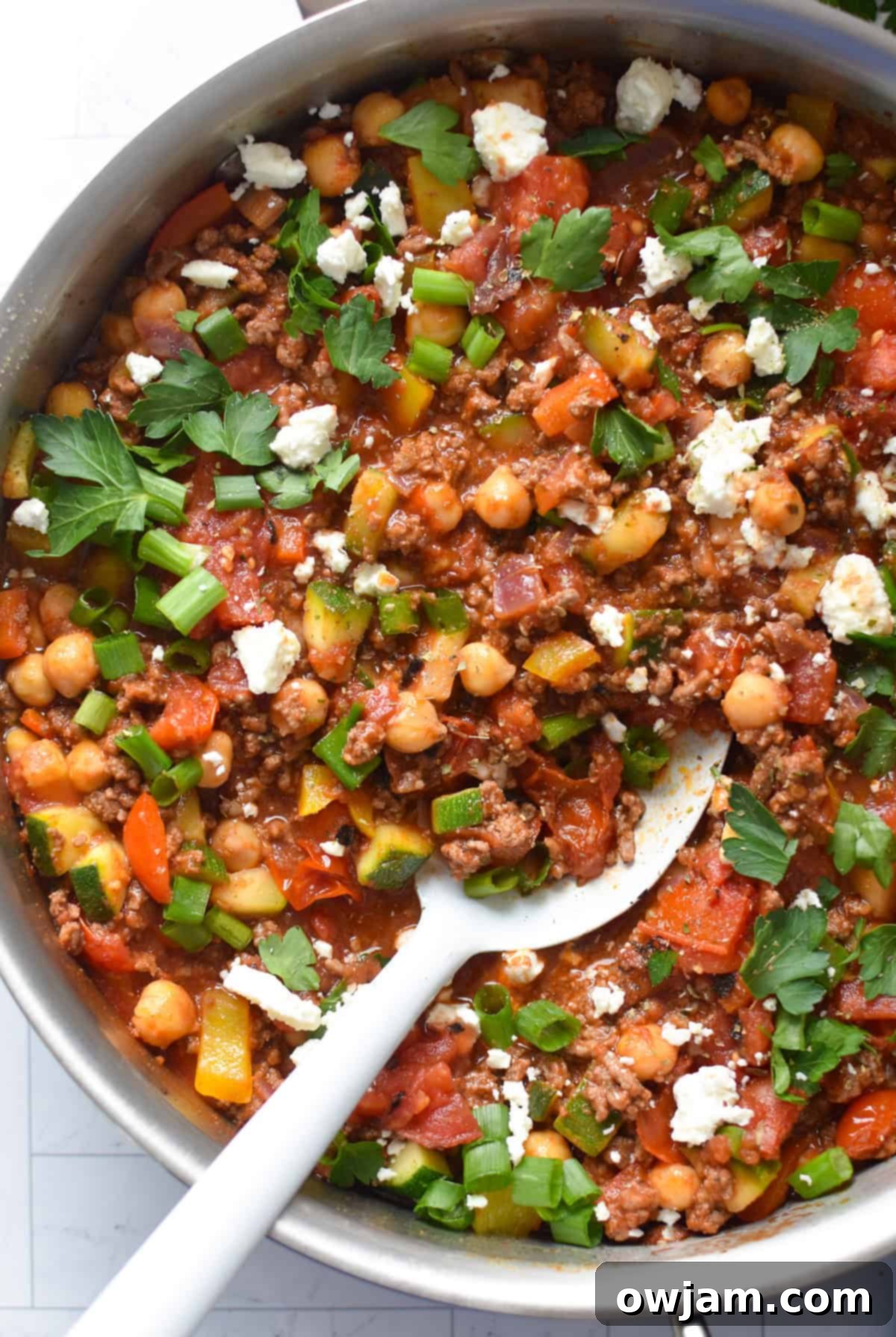 A Mediterranean Ground Beef Skillet, brimming with colorful vegetables and seasoned ground beef, ready to be served