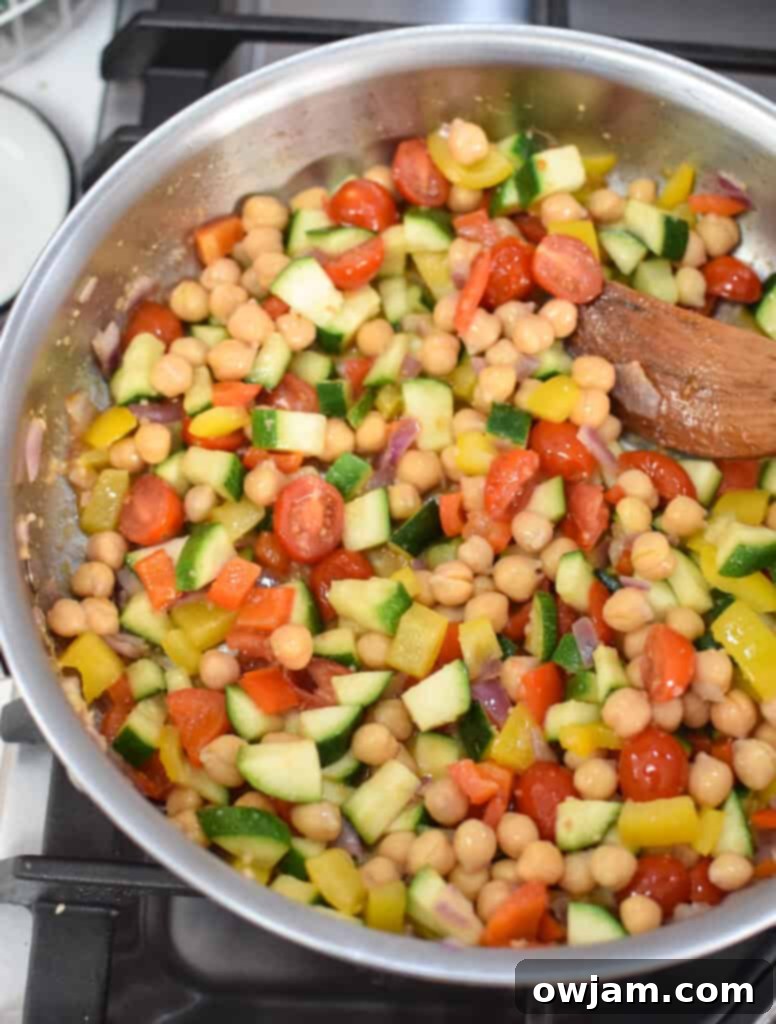 Close-up of Mediterranean Ground Beef Skillet with sautéed vegetables cooking in the pan