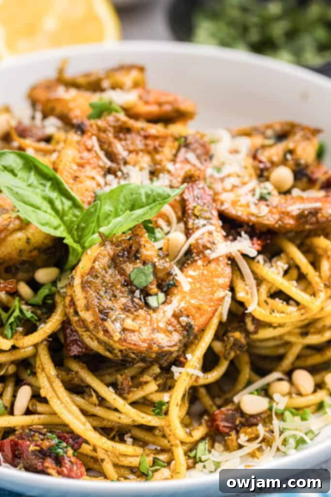A bowl of Shrimp Pesto Pasta with fresh basil garnish, ready to be served