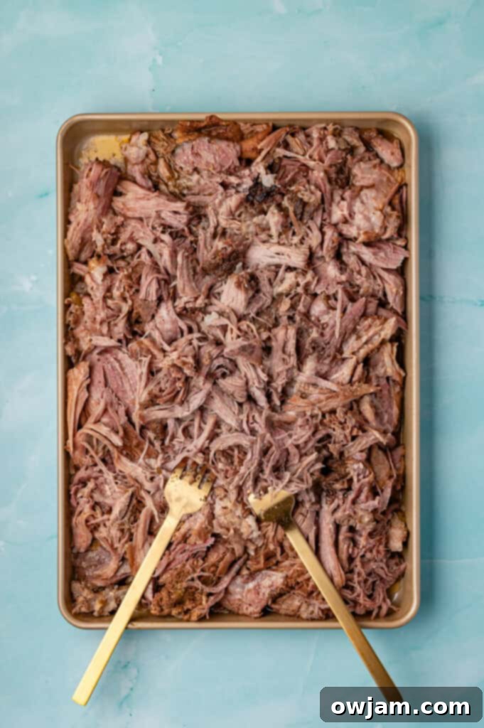 Slow Cooker Shredded Pork Tacos shredded on a baking sheet